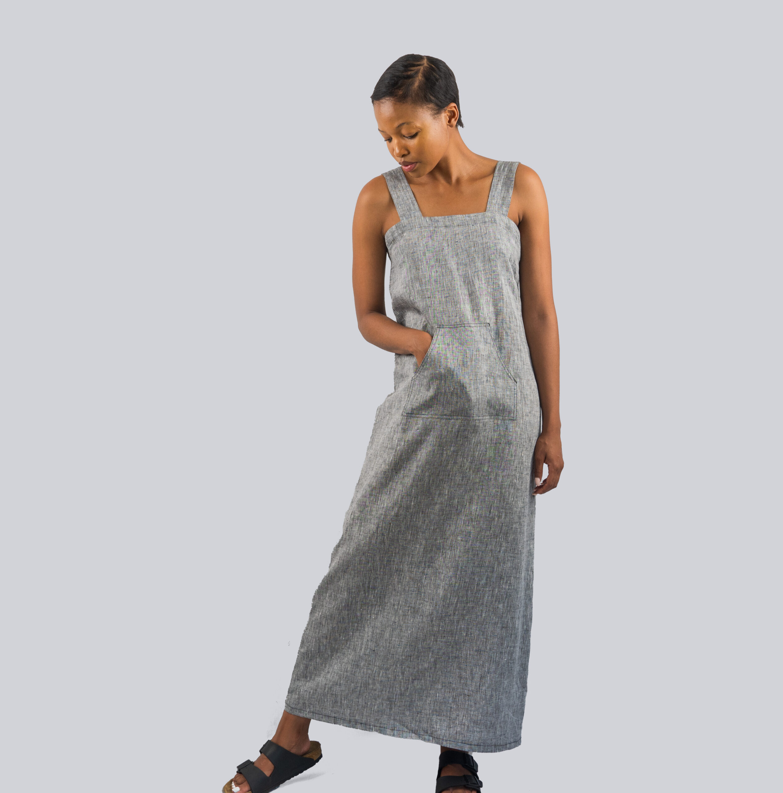 Grey Linen Dress Front - A woman wearing a maxi length grey linen dress with kangaroo pockets