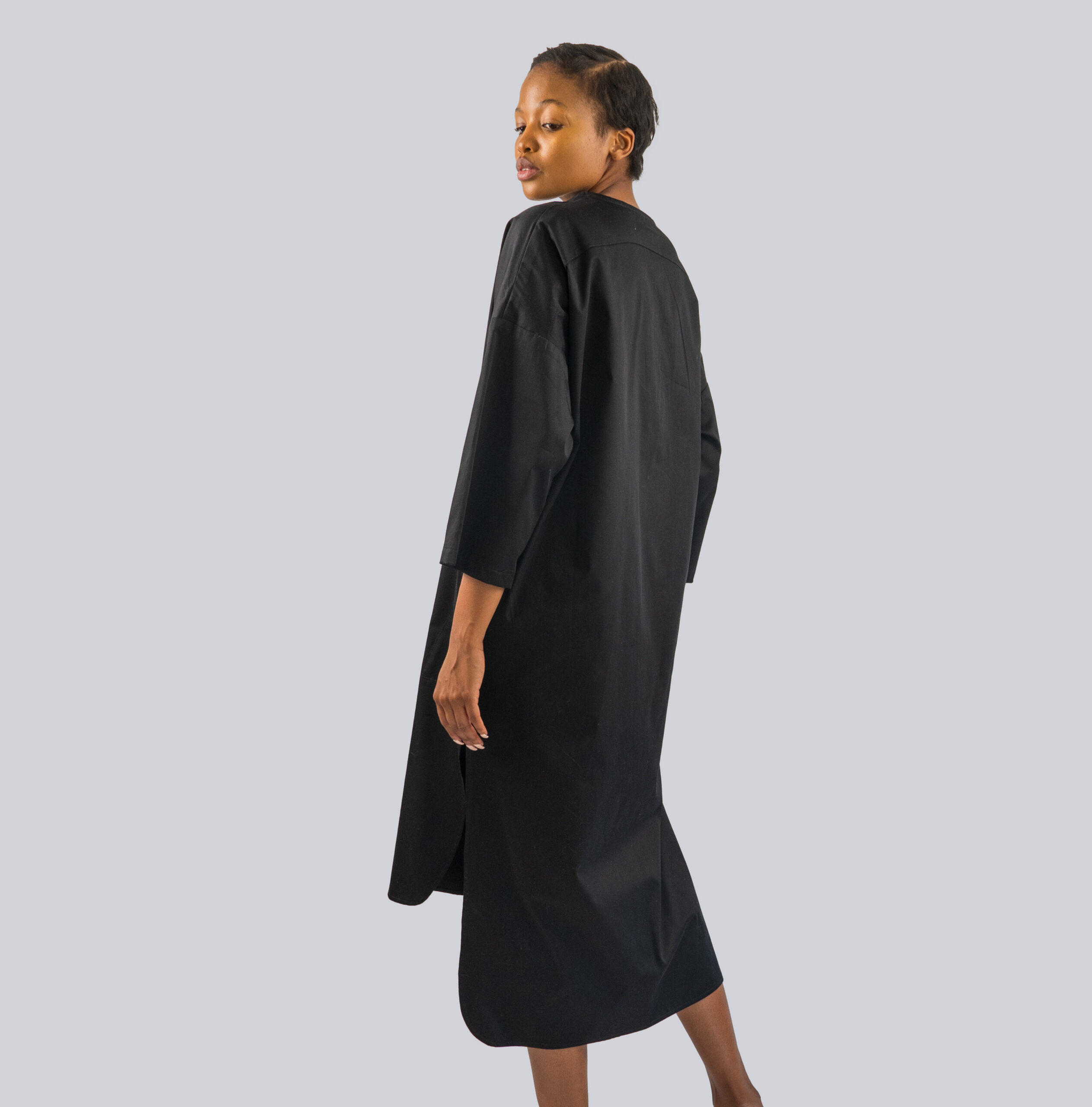 Shirt Dress Back - A back view of a collarless shirt dress. with side slit and placket