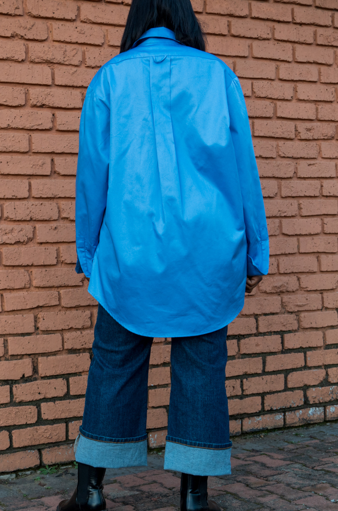 Shirt back - A back view of a woman wearing an oversized shirt