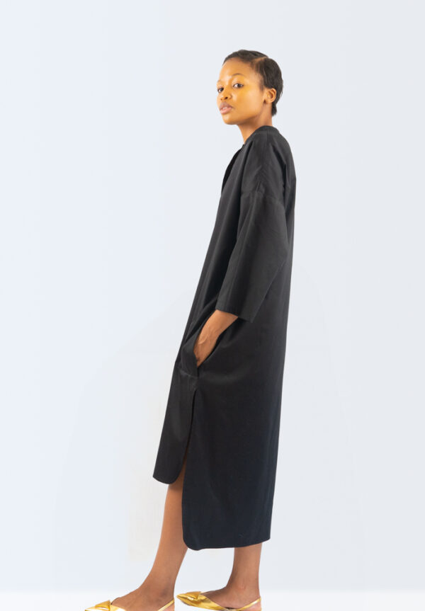A side view of a collarless shirt dress with placket