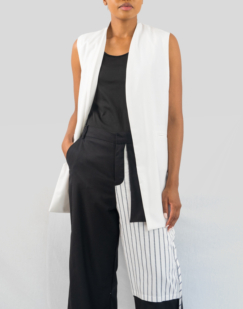 White Duster - A front view of a woman wearing a white vest outfit