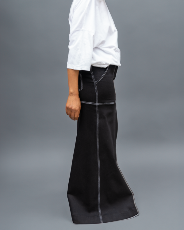 A side view of a black maxi skirt