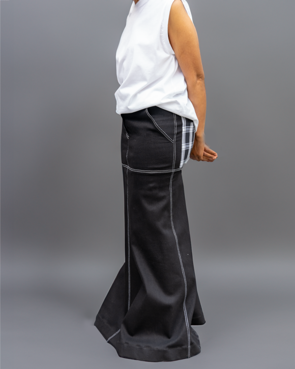 A woman wearing a black long skirt with contrast