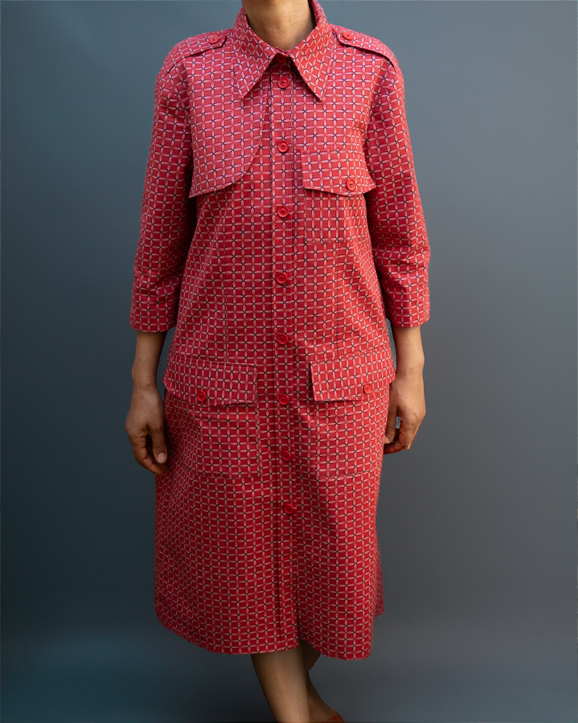 A woman wearing a red seshweshwe shirt dress