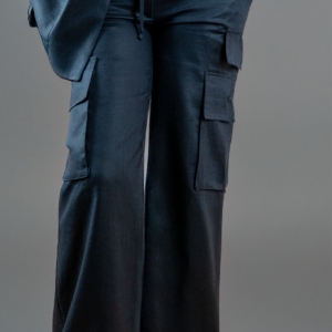A woman wearing wide leg black linen cargo utility pants