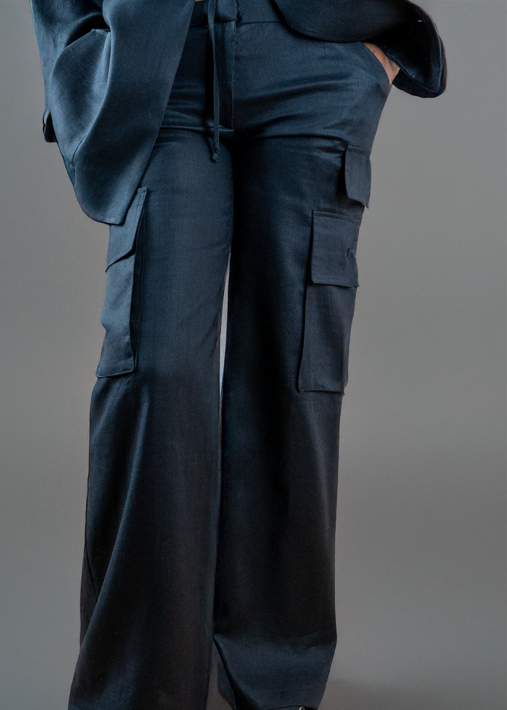 A woman wearing wide leg black linen cargo utility pants