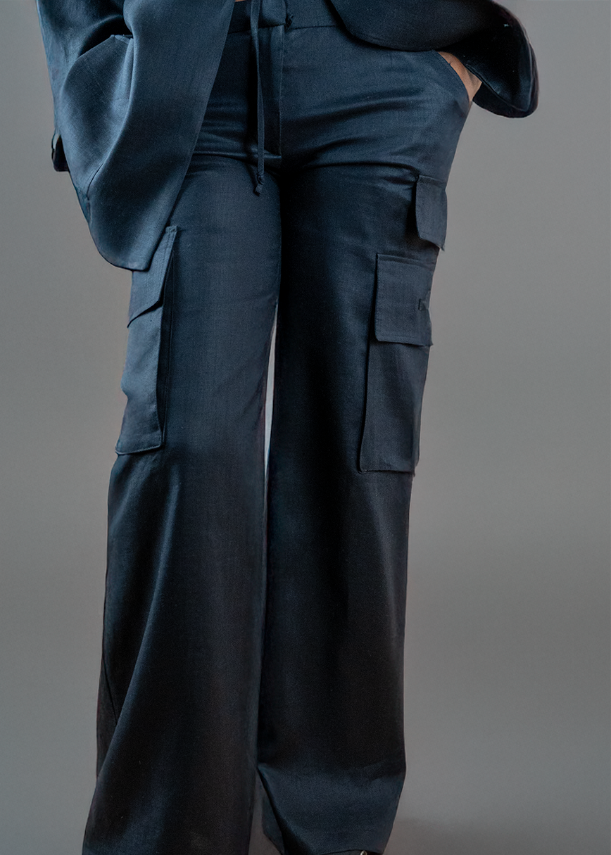 A woman wearing wide leg black linen cargo utility pants